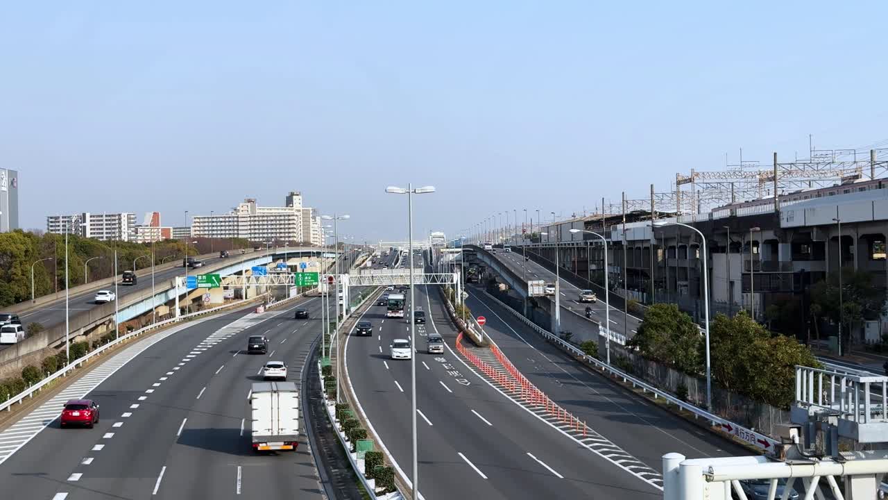 Busy Tokyo expressway intersection with clear skies and modern urban setting