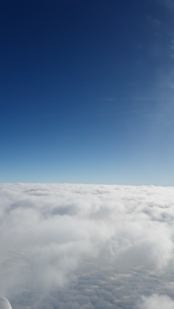 view from a plane window of the sky with the wing shot in vertical