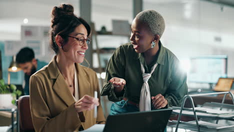 two businesswomen celebrating success with a high five in the office