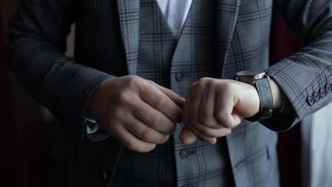 Man-put-on-wrist-watch.-Groom-dresses.-Male-businessman-is-waiting-for-meeting.-Hand-with-clock