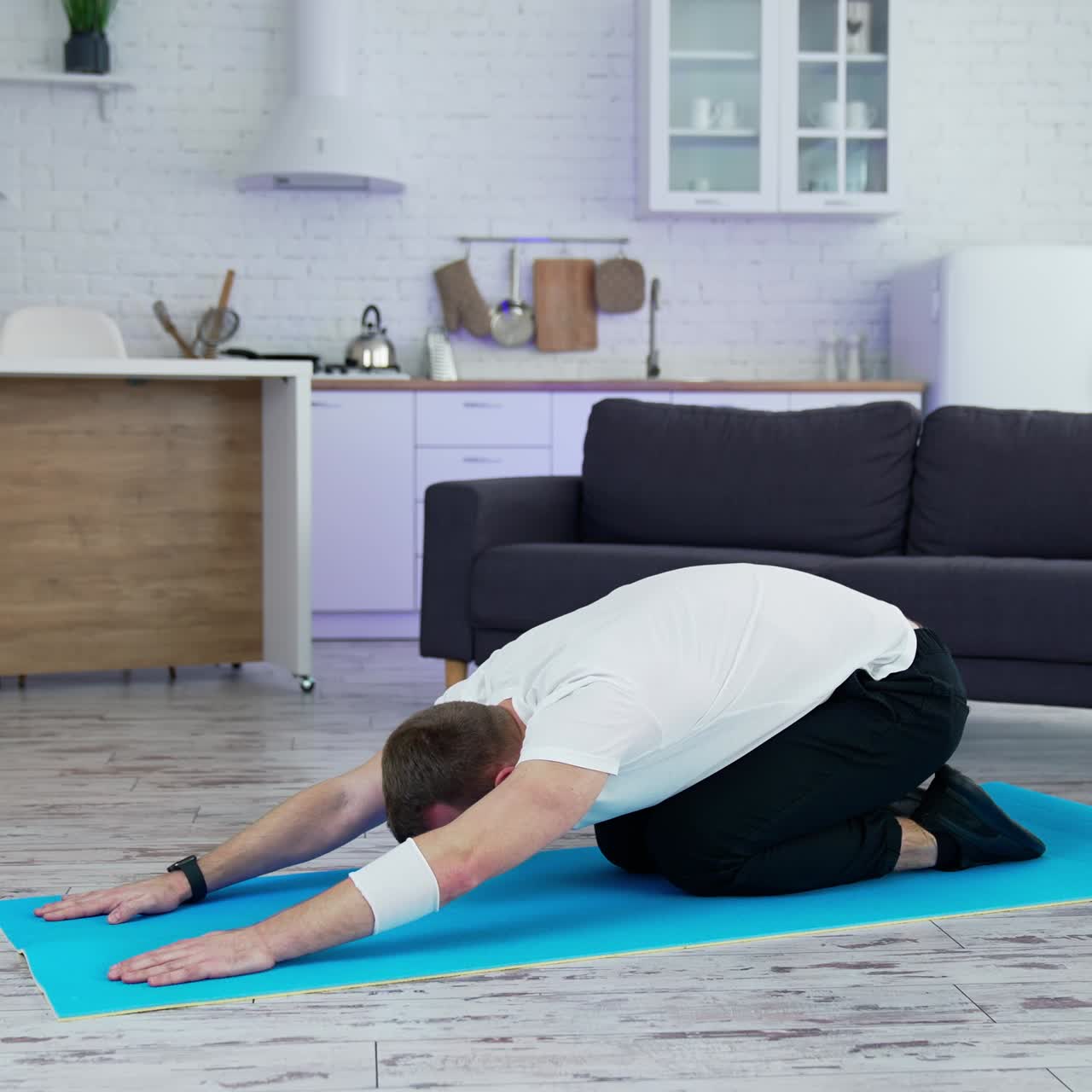 Yoga at home on mat. A man doing yoga at home on a mat