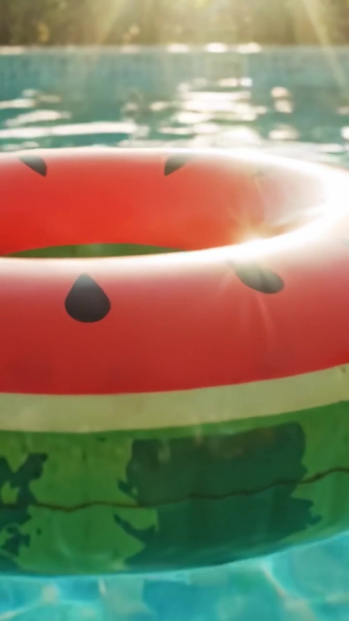 A Vibrant Watermelon-Inspired Float Drifting In a Sunlit Swimming Pool, Offering a Refreshing Escape on a Hot Summer Day