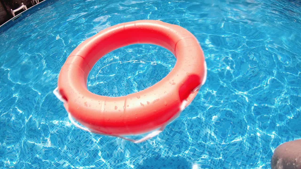 Orange Safety Lifebelt In Swimming Pool Closeup