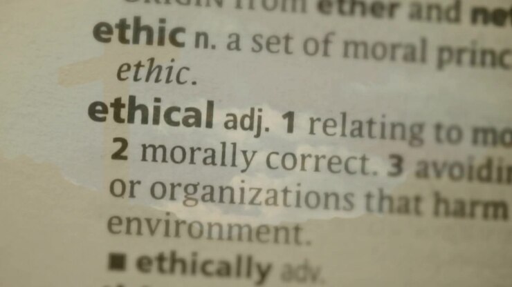 Dictionary Definition of Ethical Superimposed Over a Cloudy Sky