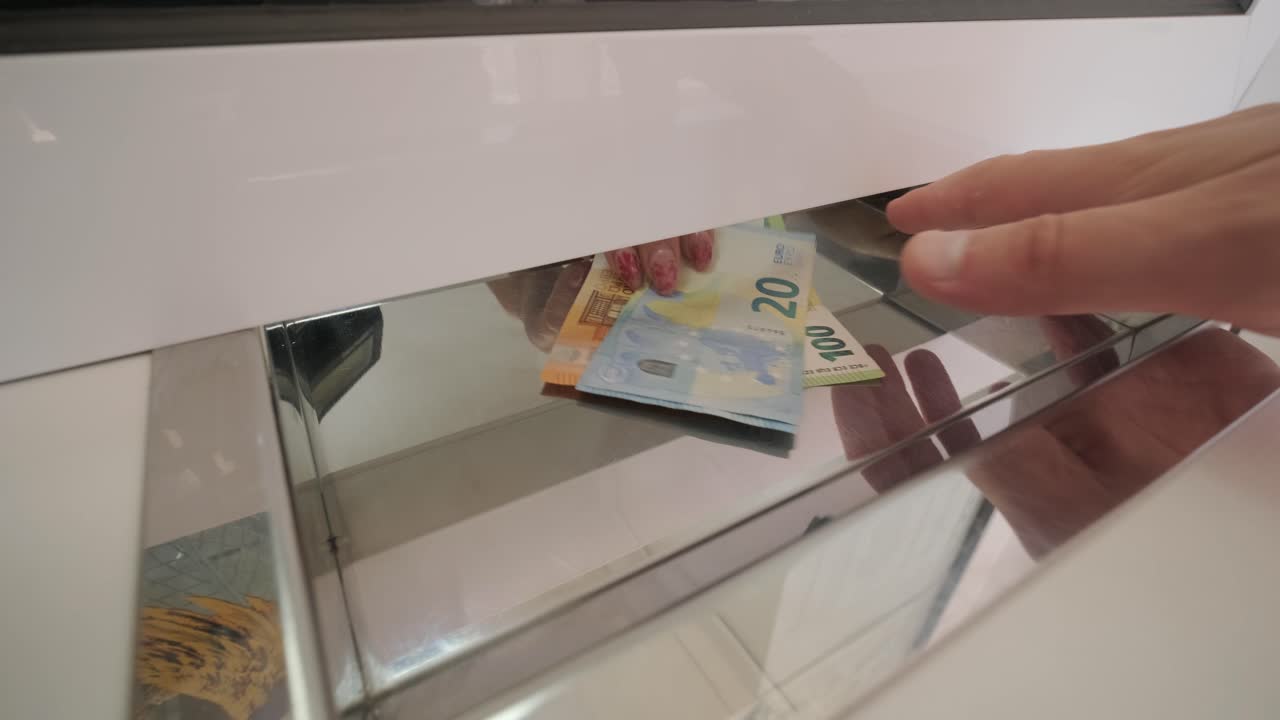 Hand Delivering Banknotes to Cash Register for Exchang