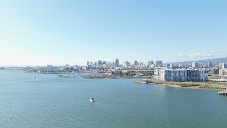 an aerial zoom out of downtown oakland california along the inner harbor.