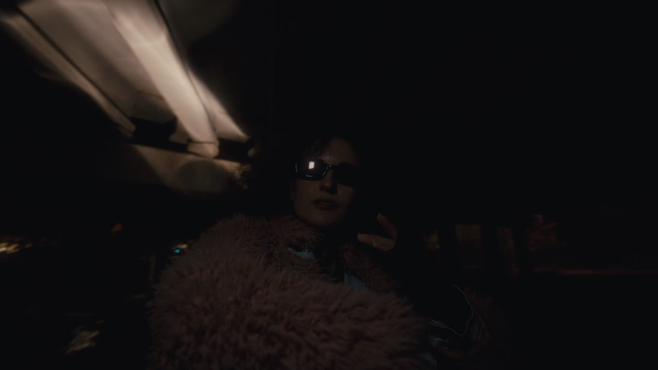 Trendy Dressed Girl in Sunglasses Dancing in Strobe Light in Night City