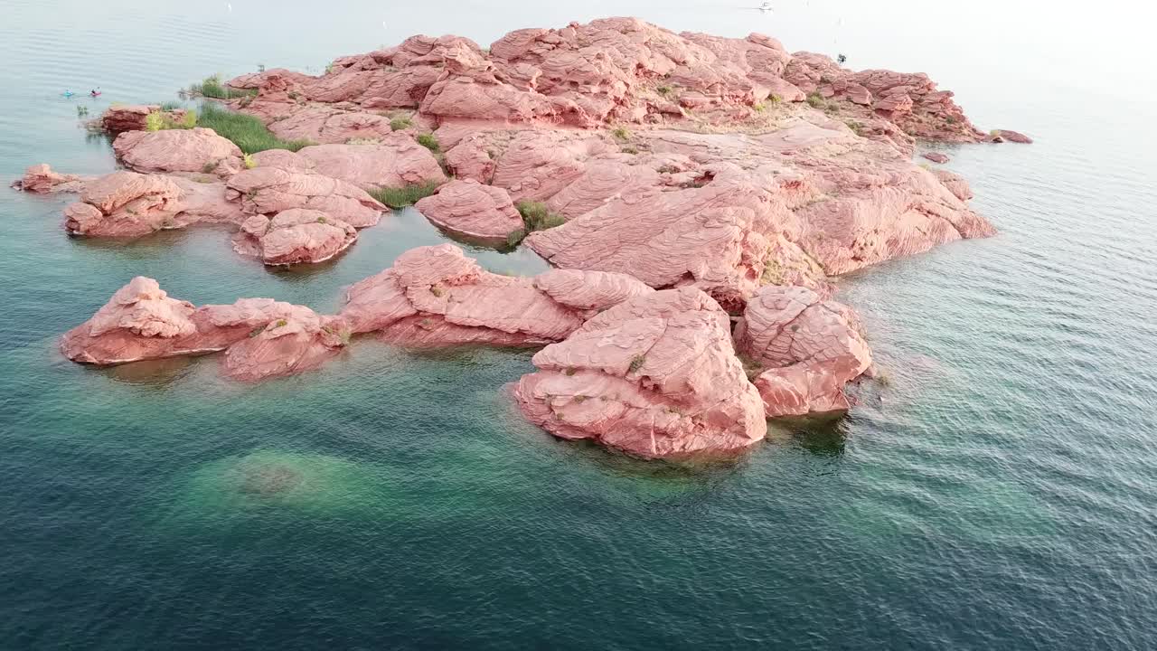 Aerial View of Red Rocky Island in Clear Lake Water. Sand Hollow State Park Reservoir and Recreational Area, Utah Desert USA