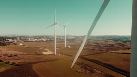 Close-Up-Of-Propeller-Of-Wind-Turbine-With-Green-Landscape-Background,-Ericeira,-Portugal