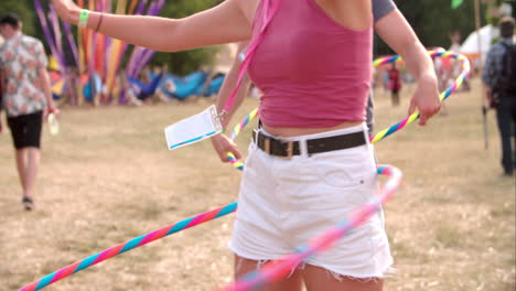 girl hula-hooping at a music festival, slow motion