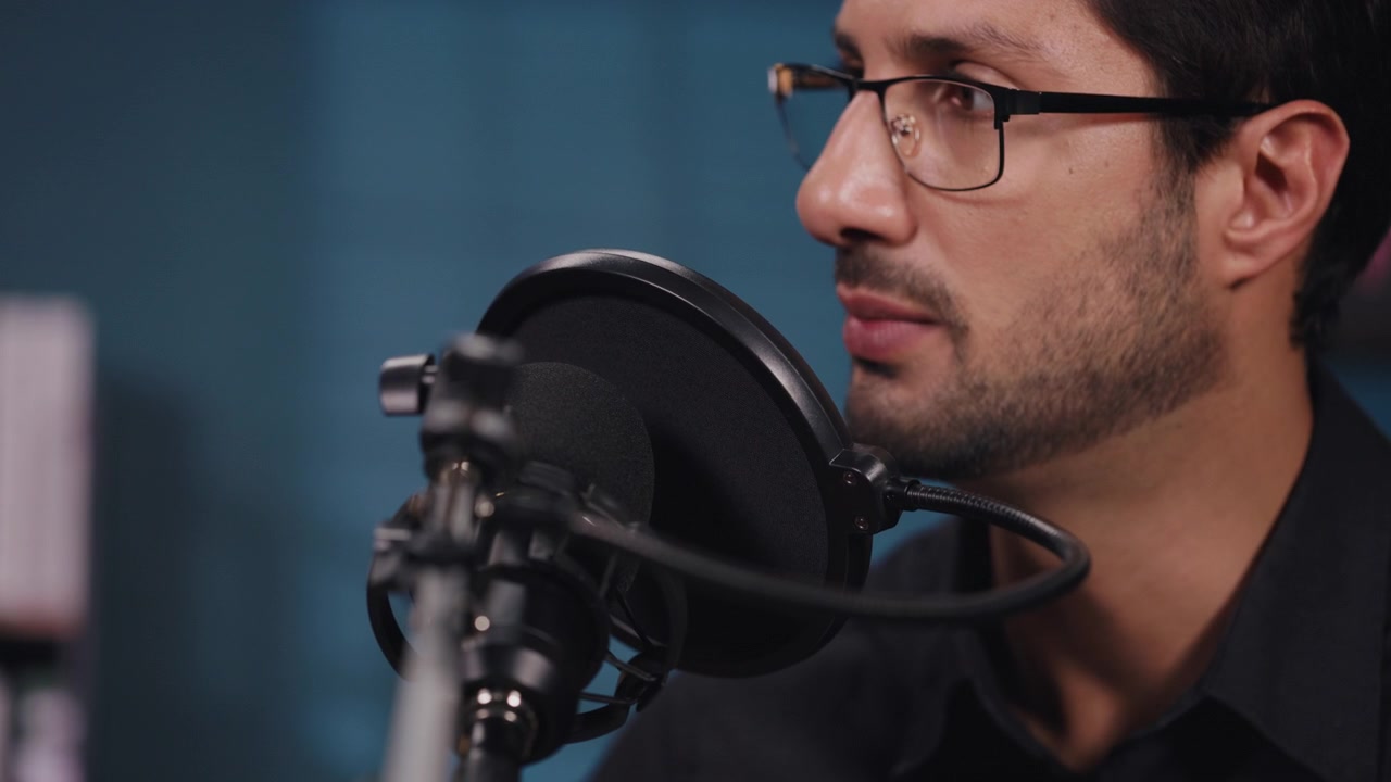 Man Speaking into Microphone in Recording Studio