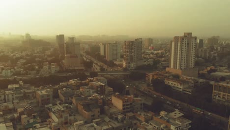 aerial over shahrah e faisal road in karachi with traffic during sunset