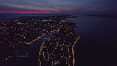 Early-morning-at-dark-Zadar-peninsula-with-city-lights-on,-aerial