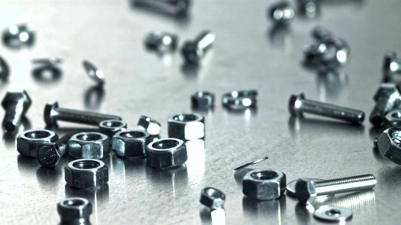 Shiny Metal Nuts, Bolts, and Washers Falling in Slow Motion