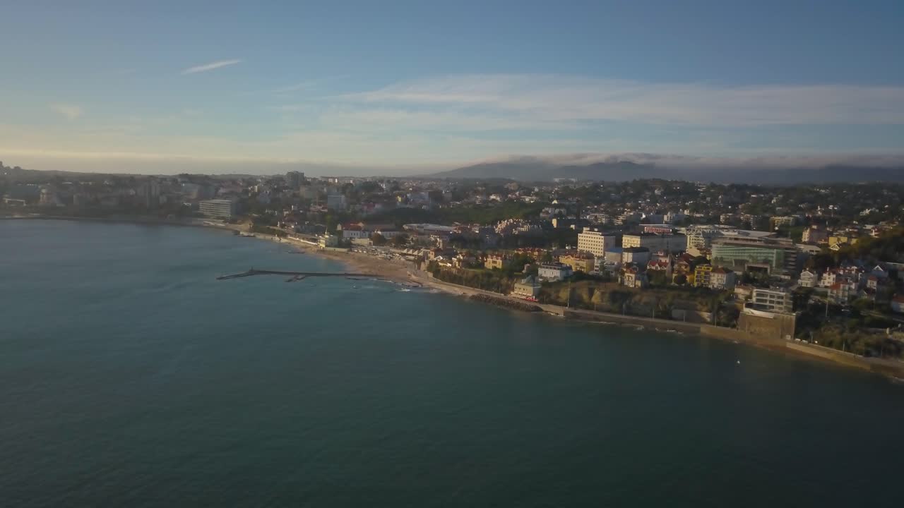 vista aérea de estoril y el castillo de forte da cruz al atardecer, en una tarde soleada