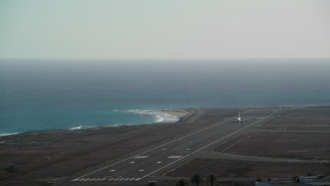 the plane takes off against the background of the sea