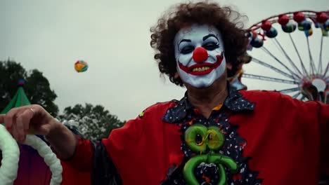 a man dressed as a creepy clown at a carnival