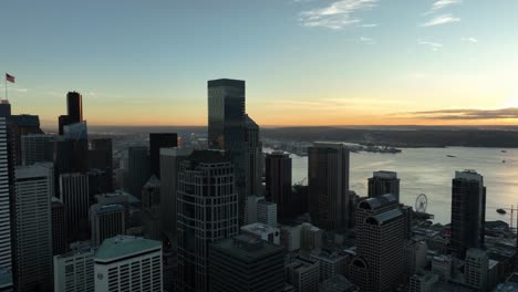 rainier square tower soars above the seattle cityscape with clear sky and bay