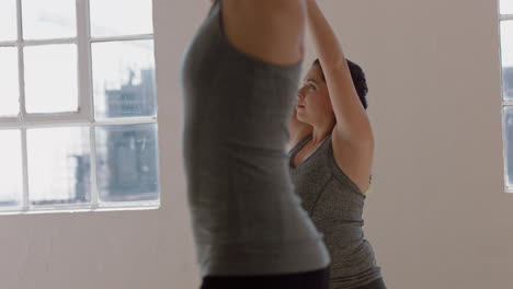 young pregnant caucasian woman in yoga class practicing warrior pose enjoying healthy lifestyle group exercising in fitness studio at sunrise