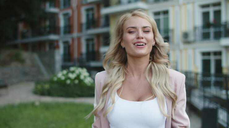 Close up view of happy business woman dancing with phone in hand outdoor