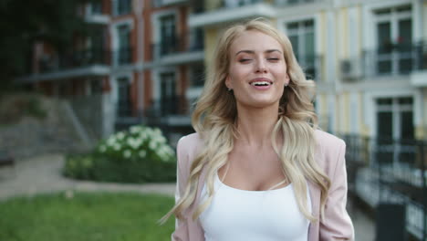 Close-up-view-of-happy-business-woman-dancing-with-phone-in-hand-outdoor