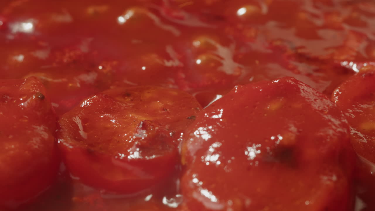 Closeup of tomatoes cooking in a sauce