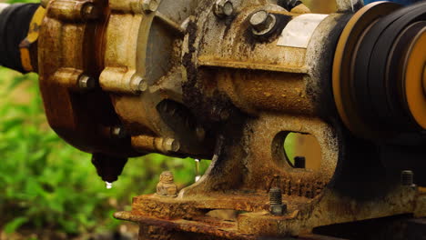 Close-up-on-vintage-water-pump-irrigating-banana-plantation-in-Vietnam