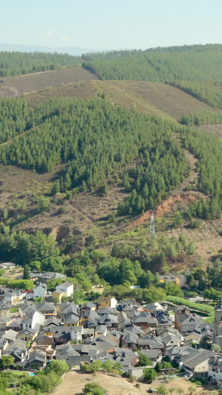 Scenic View of a Village in a Mountainous Forested Landscape