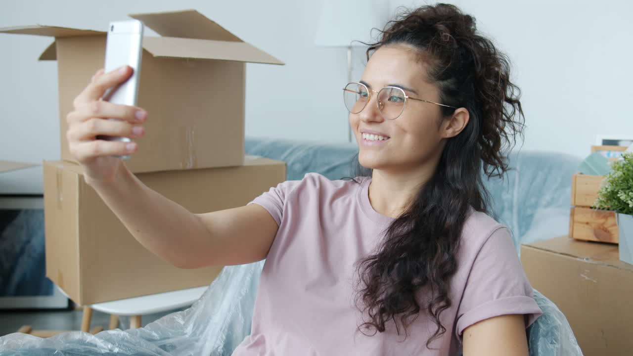 Woman Taking a Selfie During a Move