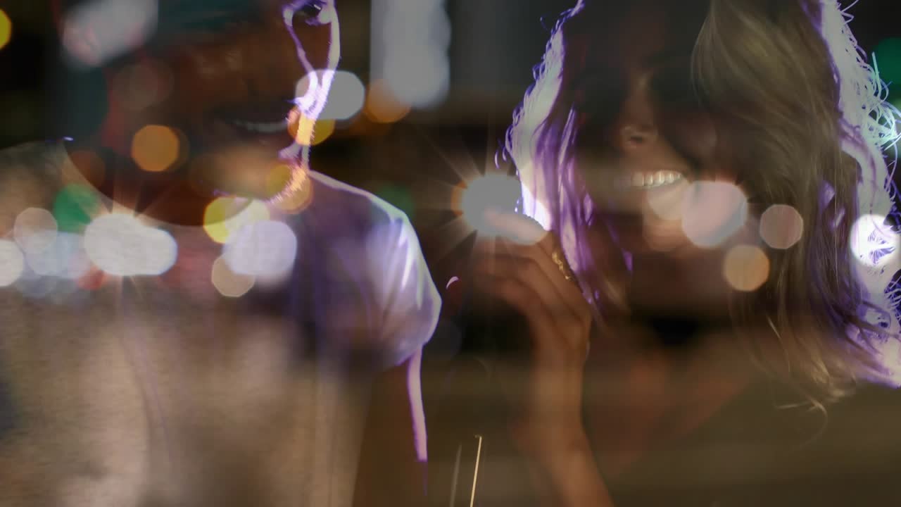 Leaning into mic, man and woman entertaining concert audience with duet amid drifting bokeh lights