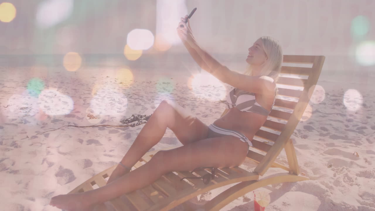 Taking selfie on beach chair, woman in bikini with animation light effects