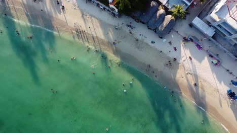 aerial of beautiful pacific beach full of holiday makers - huatulco, oaxaca state - mexico