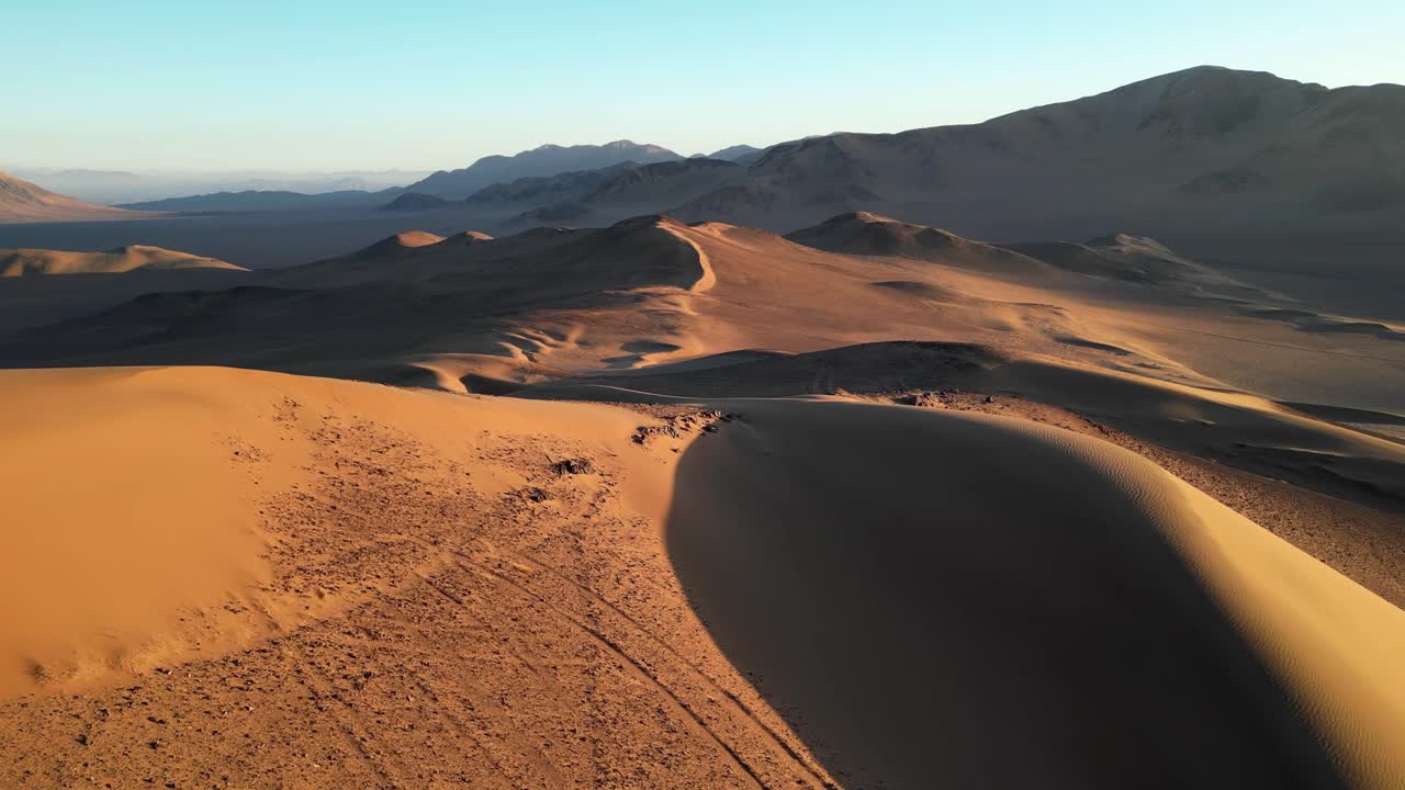 Expansive aerial view of Chile’s southern Atacama, highlighting dramatic sand formations and tranquil desert atmosphere at sunset