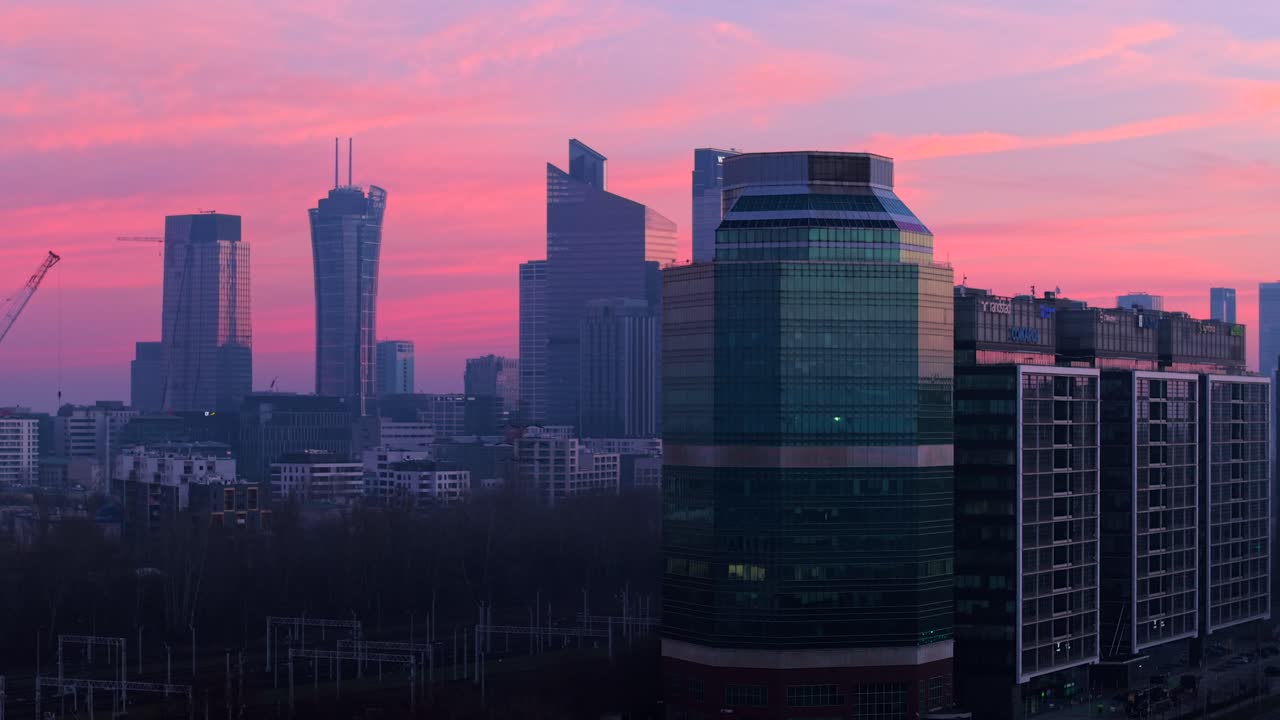 Modern city skyline at sunset in Warsaw, featuring skyscrapers in Ochota district