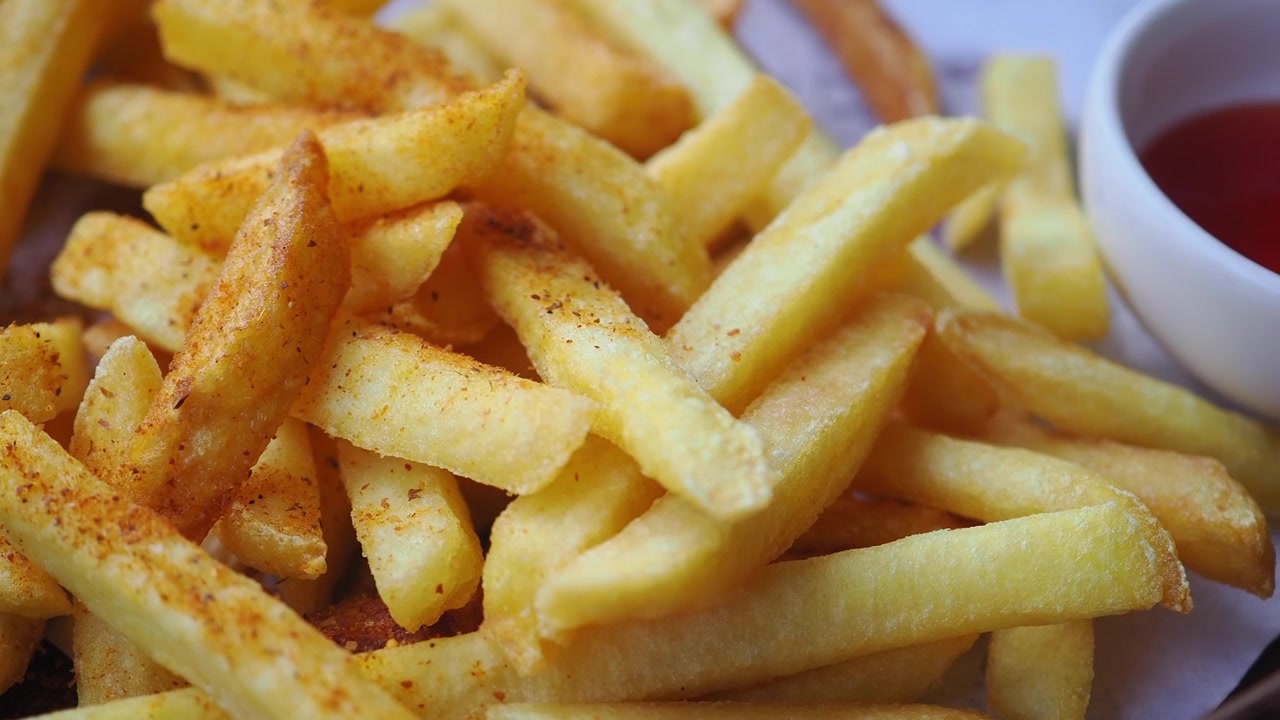 Close-up of Crispy French Fries with Dipping Sauce