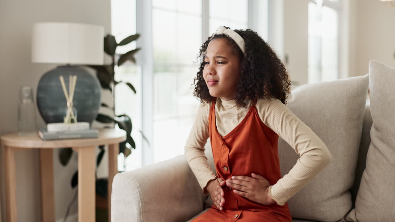 A young girl experiencing abdominal pain