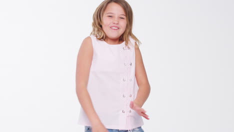 girl dancing and posing against white studio background