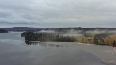 fog coming from a partially frozen lake in sweden