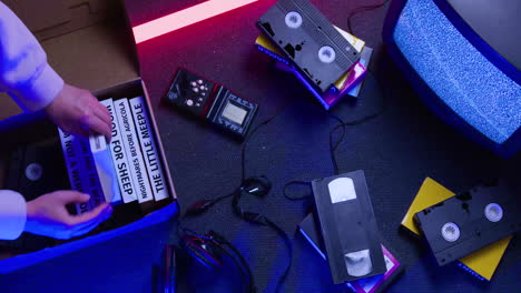 top view of vhs cassettes and television on the floor