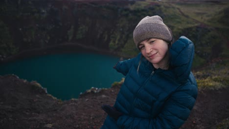 Medium-shot-of-a-cute-girl-who-points-and-references-a-massive-lake-at-the-bottom-of-a-canyon