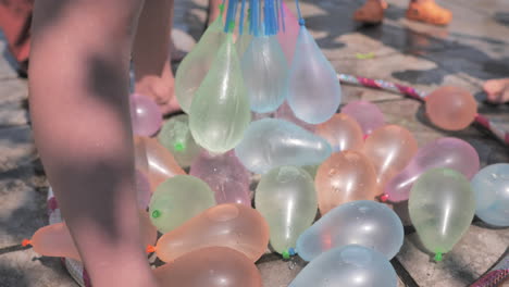 colorful water balloons being filled up