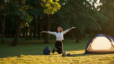 woman camping and cooking meal outdoors