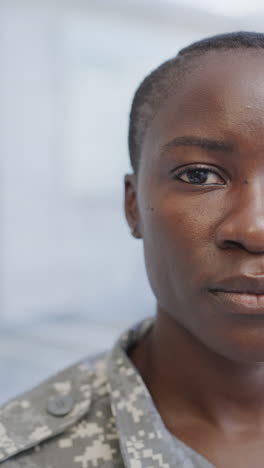 Vertical video half portrait of african american female soldier in hospital, slow motion
