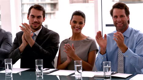 Business-team-applauding-the-camera-at-meeting