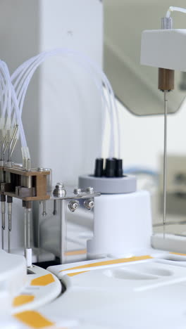 special pistons are going up and down at equipment at science laboratory. carrying out blood testing biomedical analyses in modern clinic. vertical video