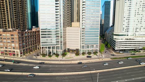 city traffic passing by downtown highrises