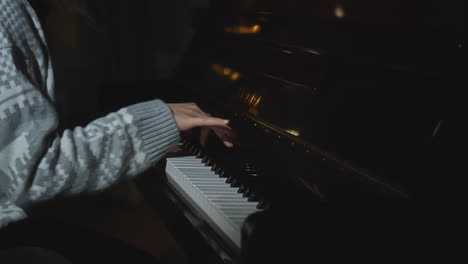 child playing piano in the dark