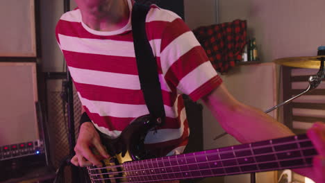 Energetic-Boy-Playing-Guitar-During-A-Band-Rehearsal-In-Recording-Studio-2