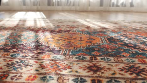 close-up of a colorful patterned rug with sunbeams