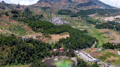 aerial dolly revealing colourful lake warna at dieng plateau, java, indonesia